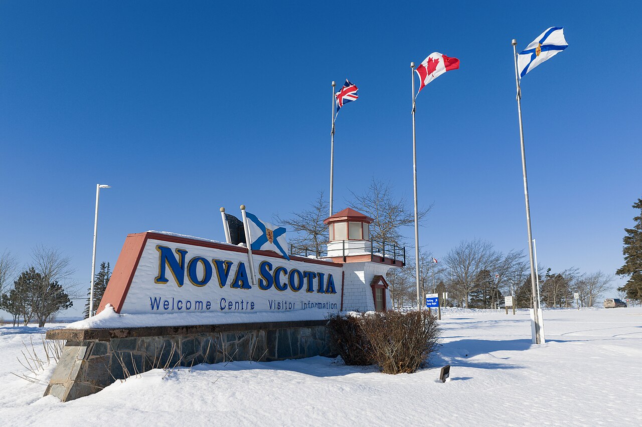 Welcome to Nova Scotia sign near Amherst showing Halifax Airport taxi service area coverage